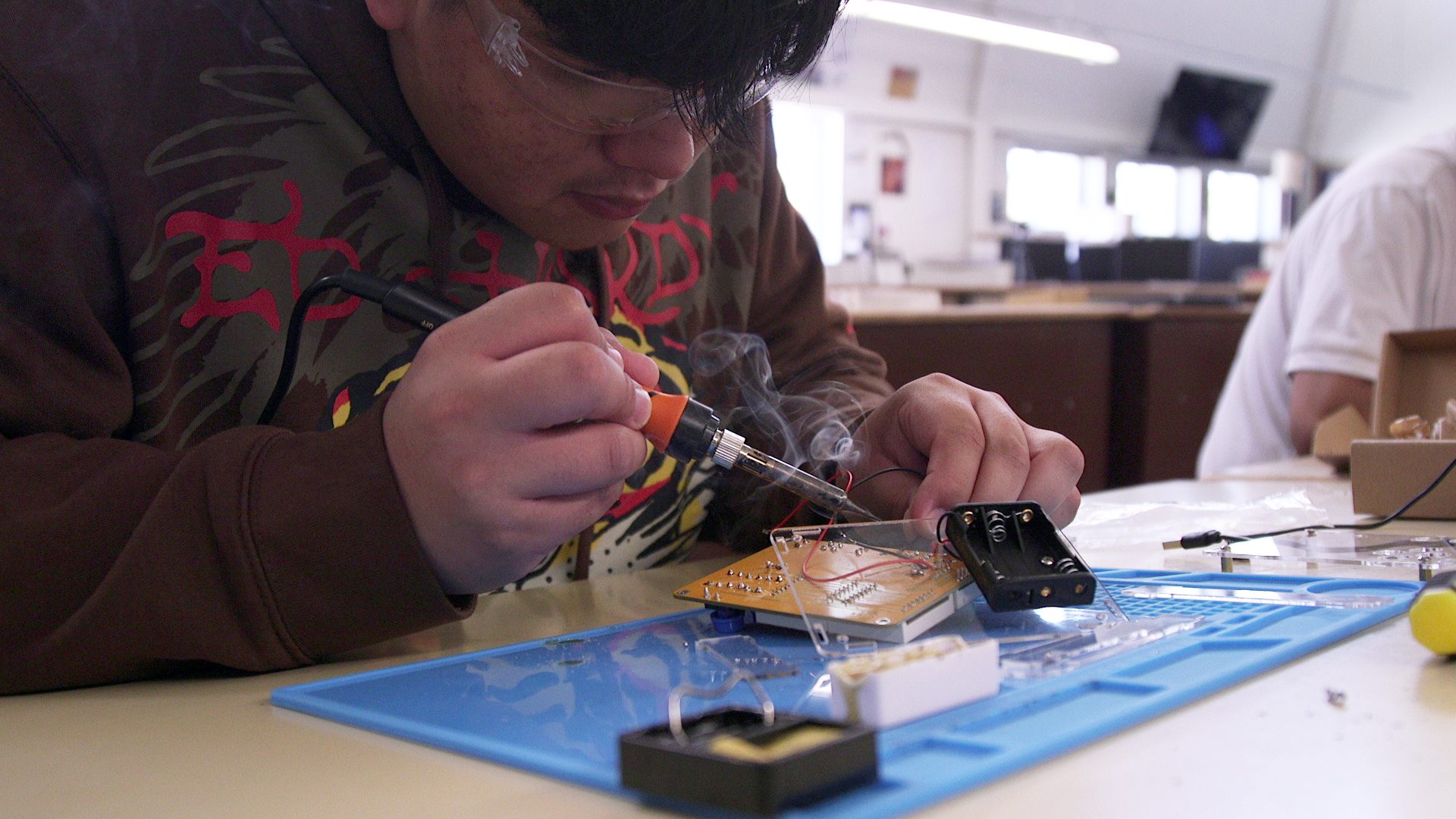 An Arroyo Grande High School student soldering components
